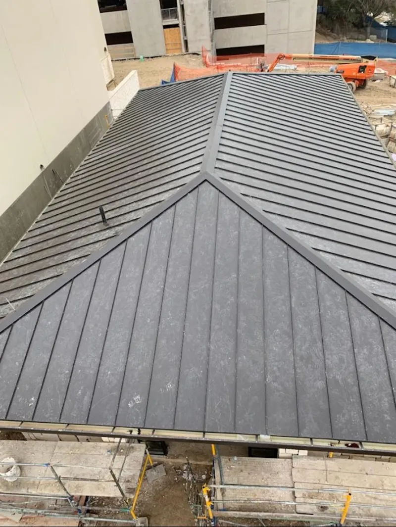Commercial metal roof construction with crane equipment in Jupiter