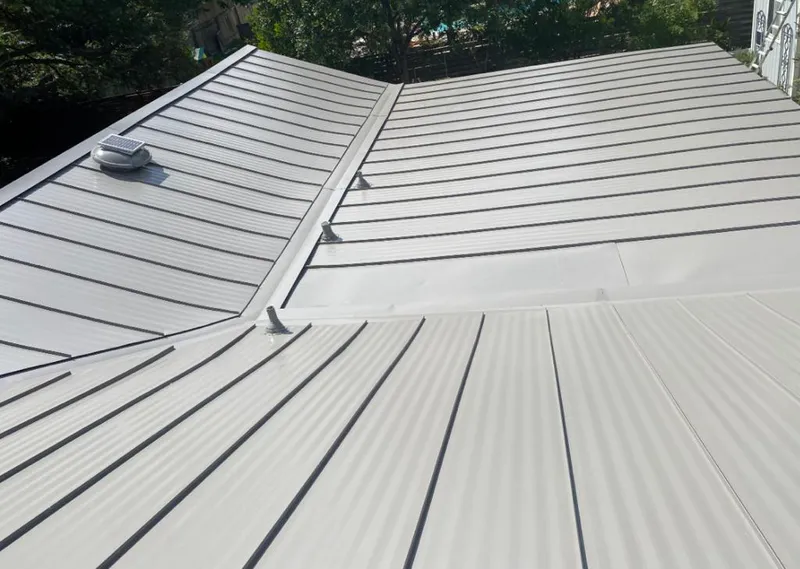 Solar attic fan installed on a metal roof for Roof Ventilation in Jupiter